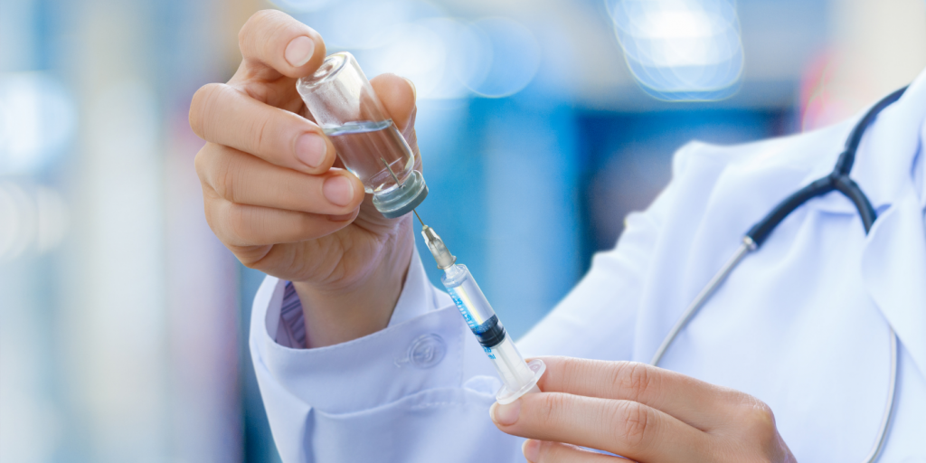 person holding a vaccine